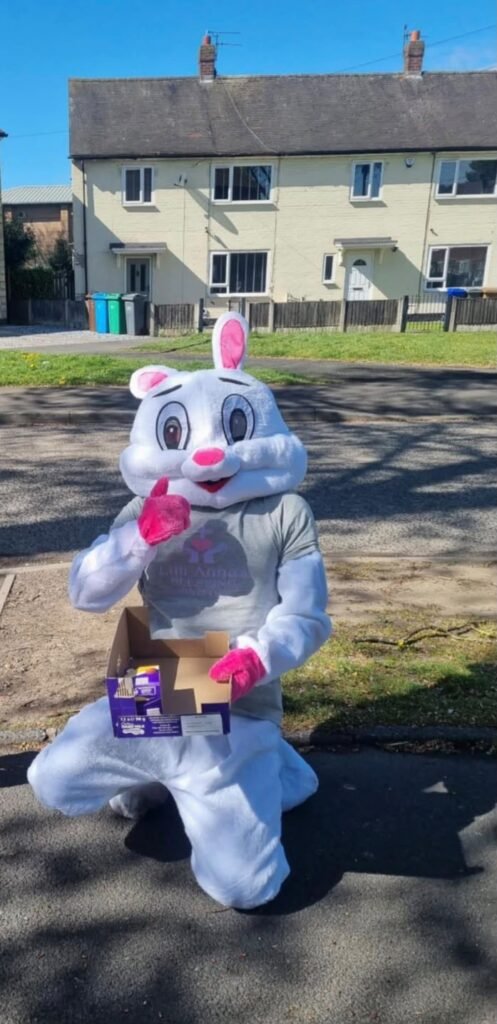 Easter bunny sharing chocolate eggs in the neighbourhood